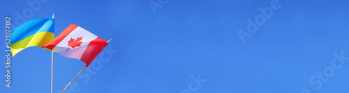 Canadian and Ukrainian flags. International partnership banner. Copy space