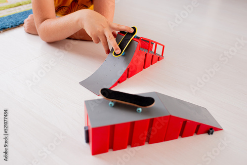 Фотография Boy Playing Fingerboard with Ramp