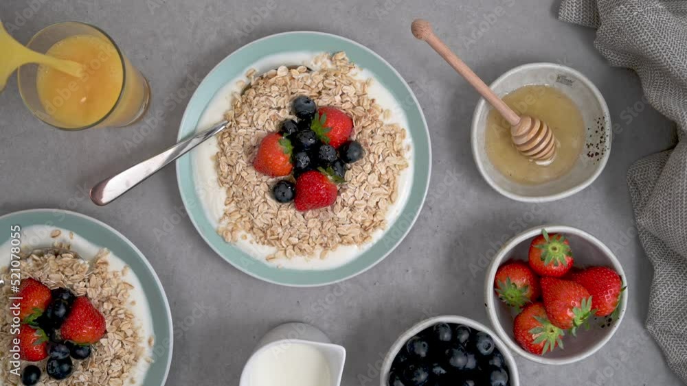 Breakfast with oats and berries and a fresh glass of orange juice Breakfast with oats and berries and a fresh glass of orange juice