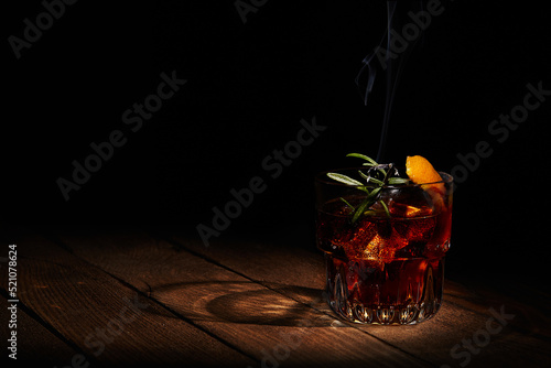 Cocktail Negroni on dark wooden board. photo