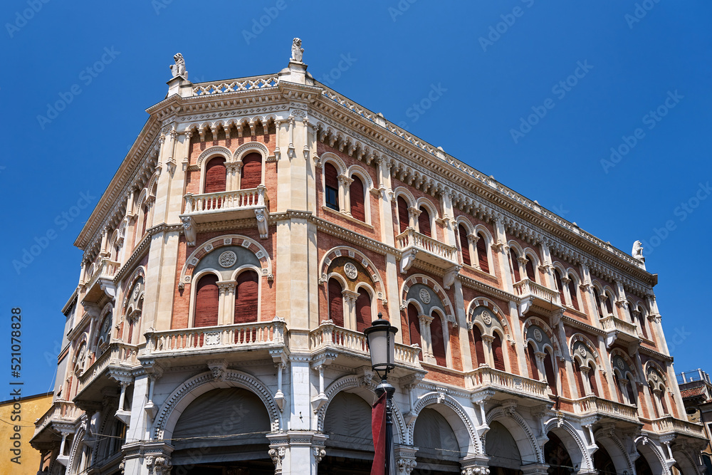 facade of a historic townhouse with balconies and shutters in the city of Padua