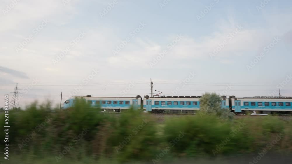 View from the side window of the car on a passing train. View from the side window of the car on a passing train.