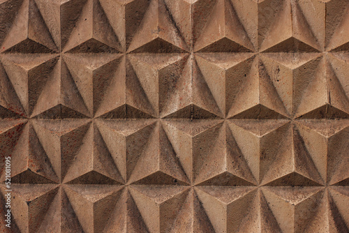 Worn decorated symetry tiles stone wall. Graphic resourse.