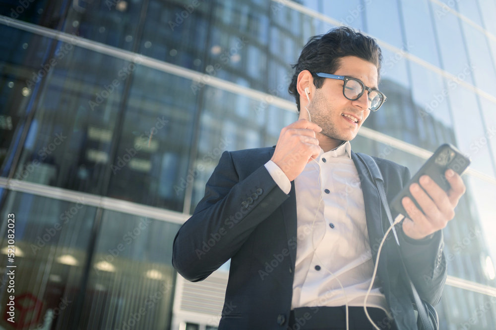 A businessman with glasses goes to work uses the phone writes a message in the chat. A businessman with glasses goes to work uses the phone writes a message in the chat.