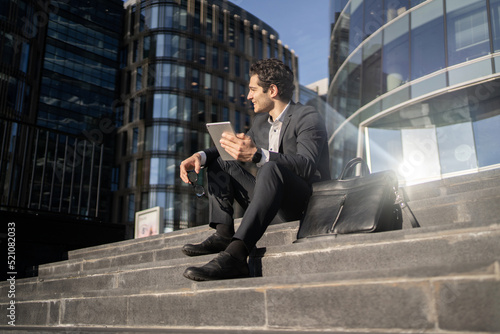 A businessman works near the office uses a laptop