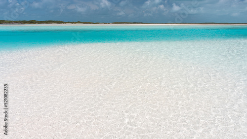 Beautiful beach with white sand, turquoise ocean water and blue sky with clouds in sunny day. Panoramic view. Natural background for summer vacation