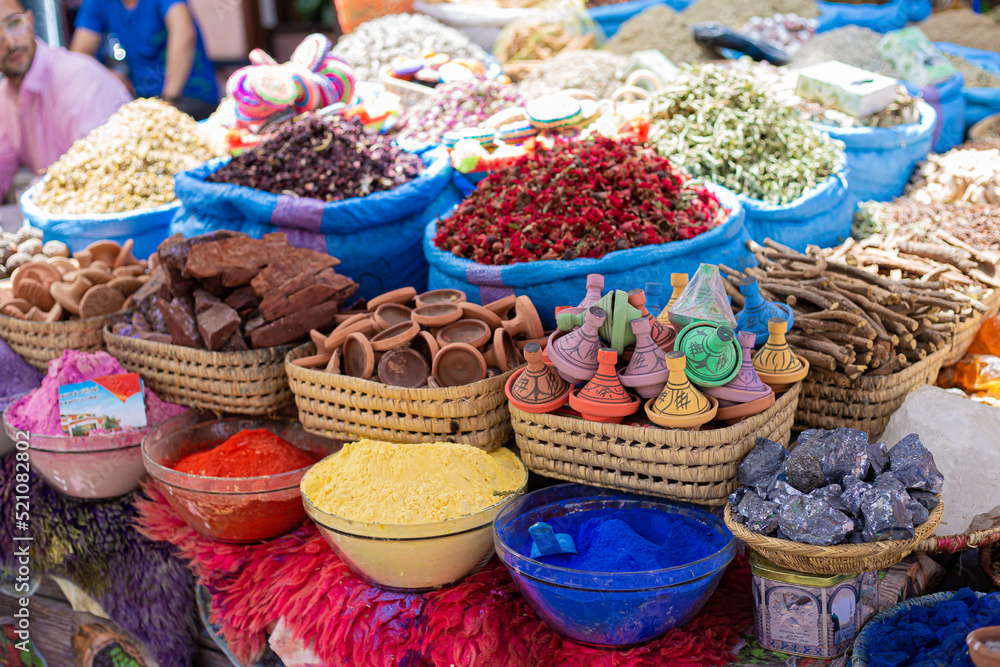 Different spices in different shapes and recipients all together in a spices market shop in Marrakesh, Morocco