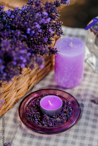 Basket with beautiful lavender in the field in Provance with Lavander water and candles. Harvesting season