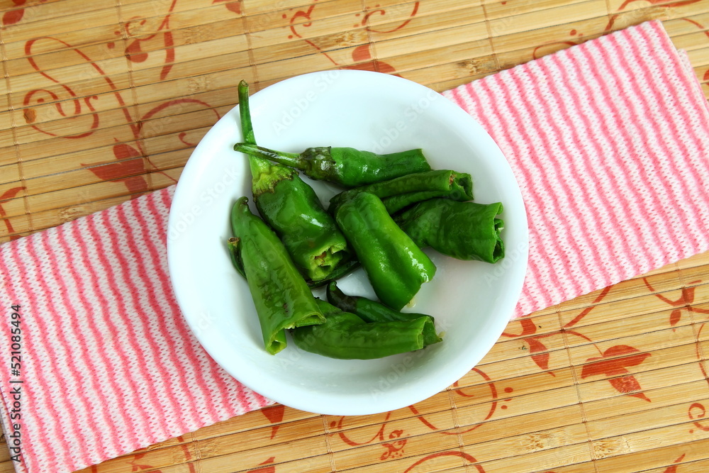 indian gujarati style chili or chilli pepper marinated and stir fry for preserving and pickle