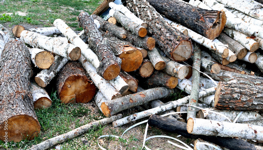 a pile of firewood, harvesting for the winter, close-up as a texture for the background a pile of firewood, harvesting for the winter, close-up as a texture for the background