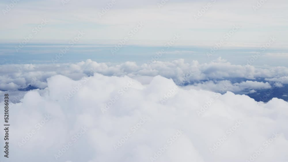 View Through Plane Window on a Beautiful Blue Sky and Sea of Clouds View Through Plane Window on a Beautiful Blue Sky and Sea of Clouds