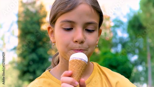 A child eats ice cream in the park. Selective focus.