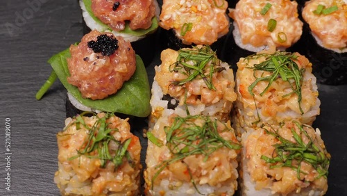 Wallpaper Mural Sushi rolls set rotating on black slate board, closeup Torontodigital.ca