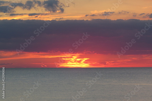 sunset glow over lake with clouds
