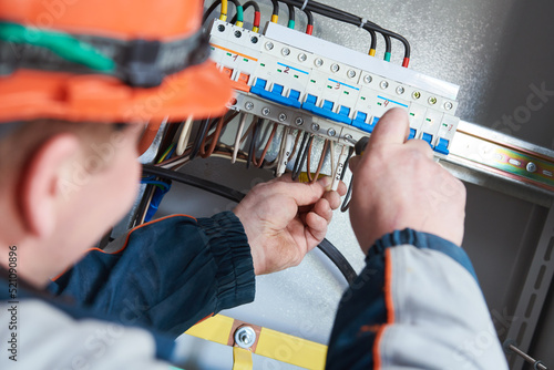 Photography Electrician screwdriving contactor in fuse switchbox