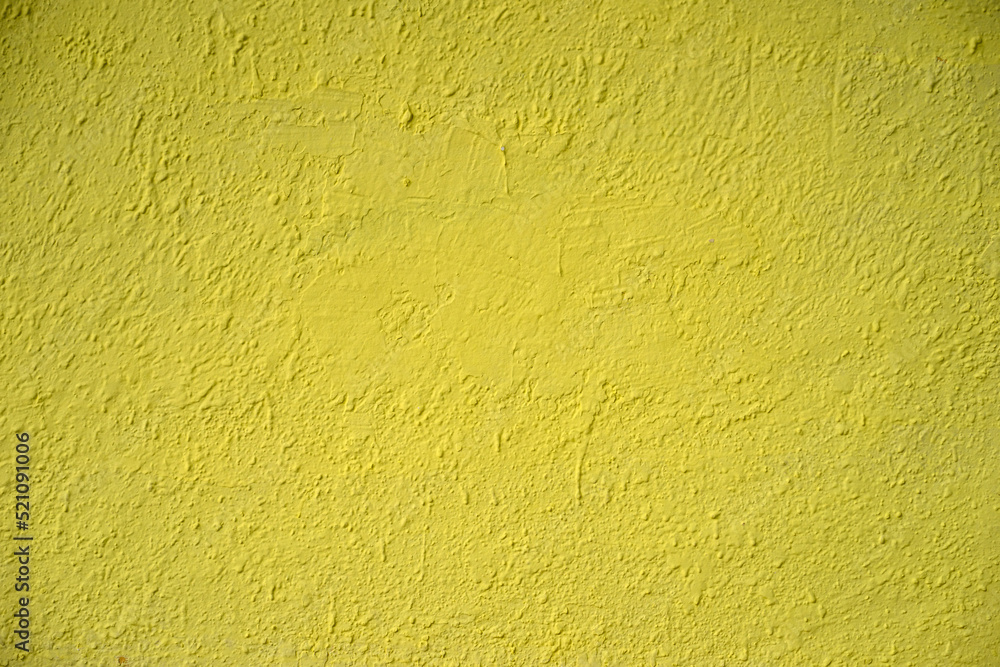 Naklejka premium Photo of the texture of the wall painted with yellow paint. Yellow concrete wall. The background is yellow for the text.