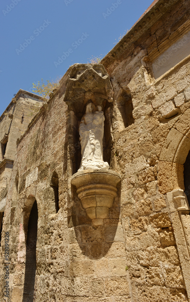 Figure of Maria and her child on a wall on a historical building in Rhodes, Greece