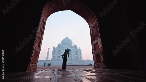 Silhouette woman in saree Indian dress costume dancing in Taj Mahal India