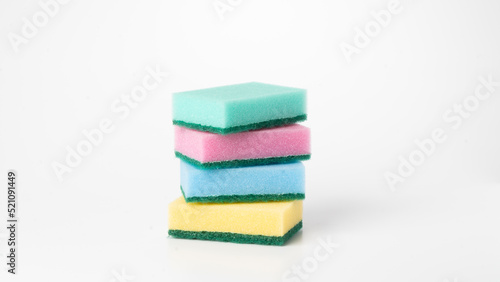 Multicolored sponges in a stack on a white background