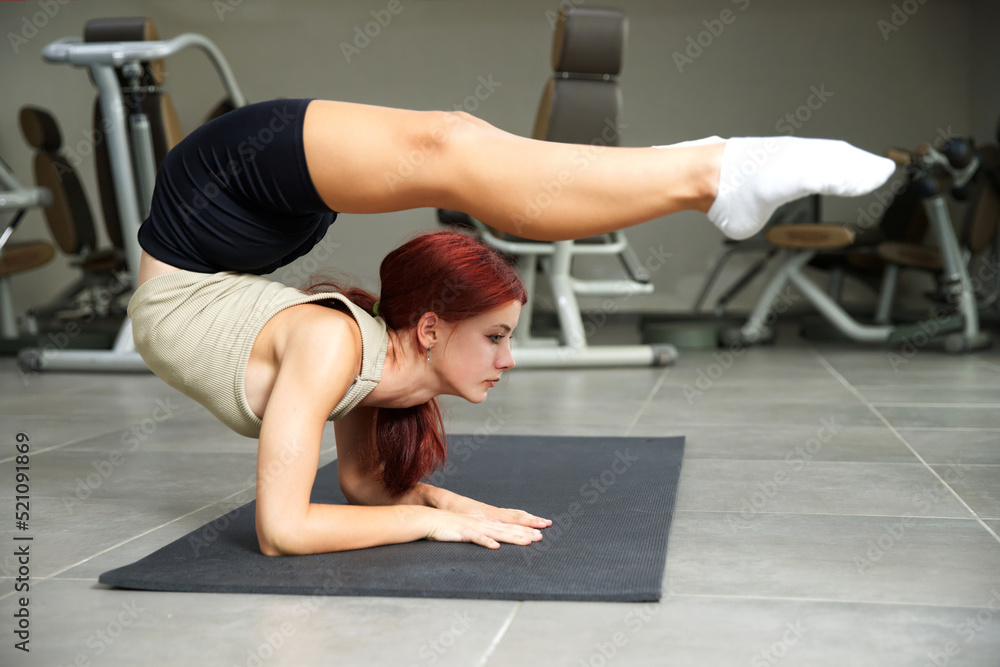 Flexible girl doing exercises for the spine. Athlete model. Gymnastics Flexible girl doing exercises for the spine. Athlete model. Gymnastics