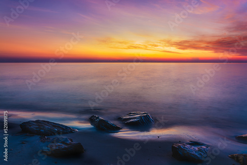 sunset sky with dramatic sunset clouds over the sea. Beautiful sunrise over Ocean