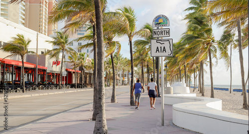 two people walking on north a1a sign in ft lauderdale beach florida  photo