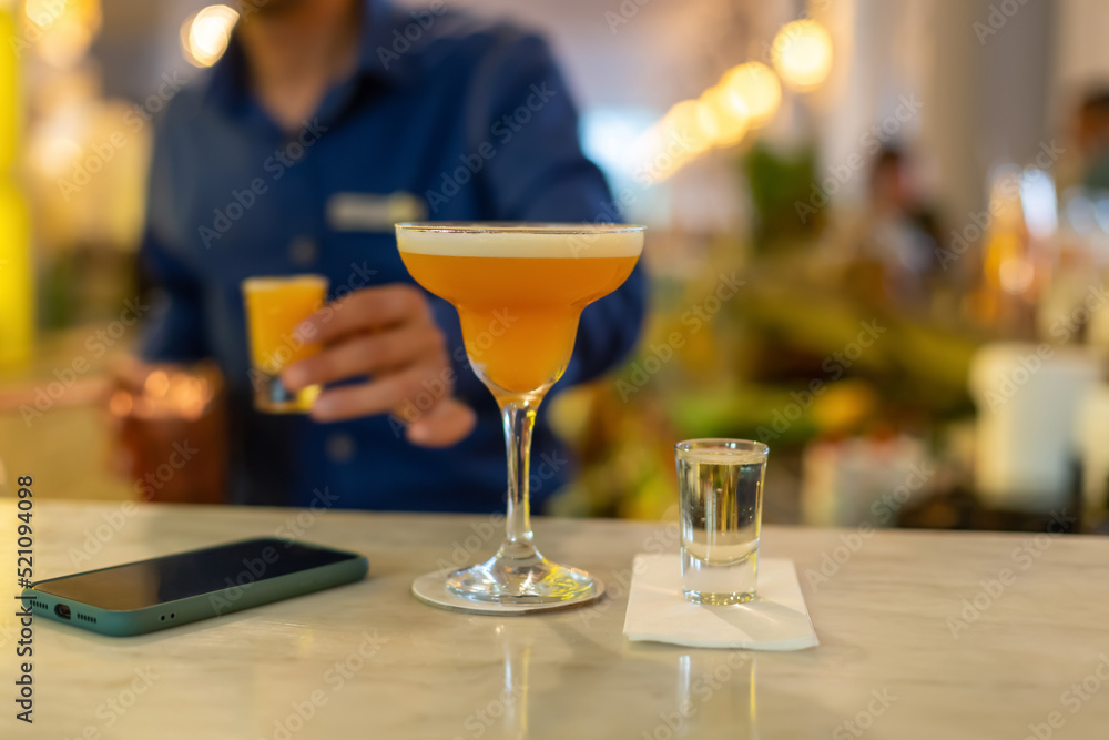 Blurred photograph, An alcoholic cocktail prepared at the bar.