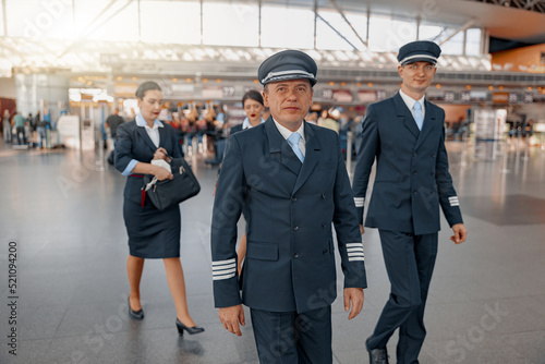 Two pilots walking along the airport terminal