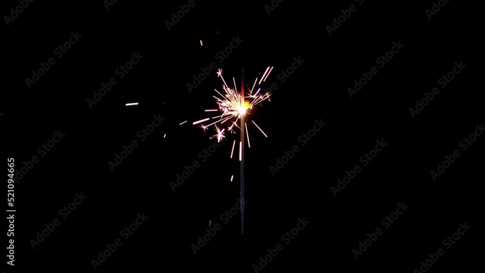 Lightening sparkler on the black background. Sparkler concept. Bengal lights are burning on a black background. Holiday party concept. Newyear party sparkler. Lightening sparkler on the black background. Sparkler concept. Bengal lights are burning on a black background. Holiday party concept. Newyear party sparkler.