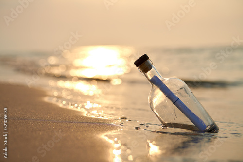 Fototapeta Naklejka Na Ścianę i Meble -  Bottle with a message on sea or ocean beach. Hope concept