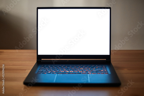 Laptop or notebook with blank screen on wood table. Clipping path.