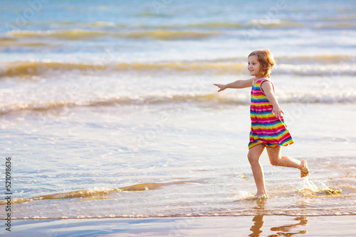 Kids play on tropical beach. Sand and water toy.