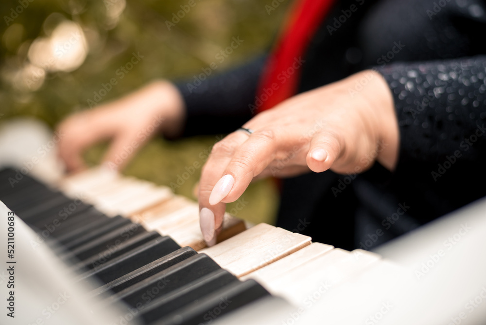 Fototapeta premium close-up female hands playing the piano