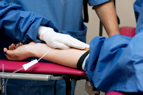 medical procedure, the doctor takes blood from the patient's vein, close-up