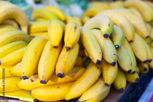 mature dessert bananas in basket on counter in market