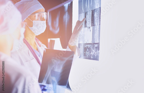 Two female women medical doctors looking at x-rays in a hospital.
