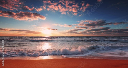 Beautiful ocean beach sunrise and splashing waves on the sea sand, 4K video of nature landscape, seascape view
