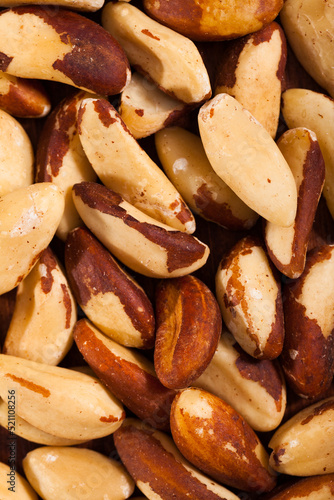 Closeup of shelled roasted Brazil nut seeds as background..