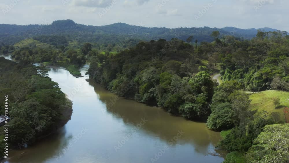 Aerial Drone View of Rainforest River and Mountains Scenery in Costa Rica at Boca Tapada, San Carlos River (Rio San Carlos) that Connects to Nicaragua in Central America, High Shot Above Trees Aerial Drone View of Rainforest River and Mountains Scenery in Costa Rica at Boca Tapada, San Carlos River (Rio San Carlos) that Connects to Nicaragua in Central America, High Shot Above Trees