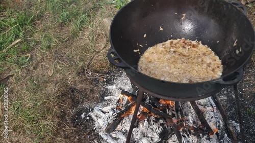 Cossack kulish. onions, meat and lard are cooked in a cast-iron cauldron on fire. The main field porridge of Ukraine photo