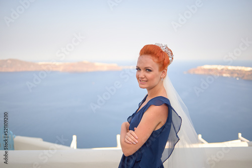 Outdoor shot of young beautiful red-haired bride