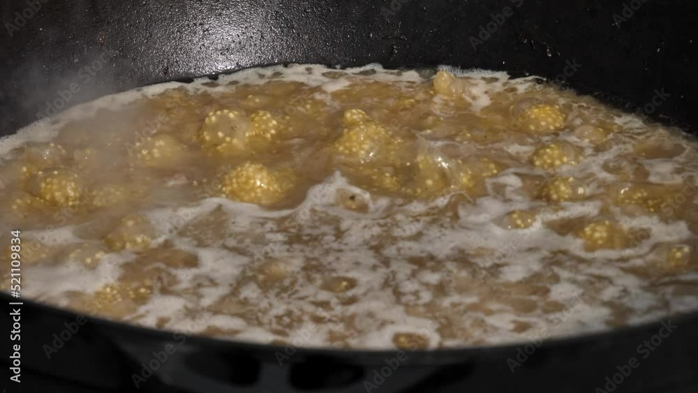 cooking KULESH. stirring boiling millet porridge in a cast-iron cauldron on fire. OLD AND VERY DELICIOUS FOOD OF WARRIORS AND TRAVELERS OF UKRAINE cooking KULESH. stirring boiling millet porridge in a cast-iron cauldron on fire. OLD AND VERY DELICIOUS FOOD OF WARRIORS AND TRAVELERS OF UKRAINE