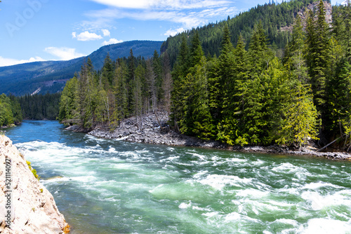 bright colourful flowing river in the mountain forests