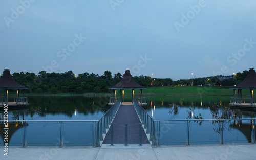 A picture with noise effect of gazebo at the lake during sunset and blue hour.