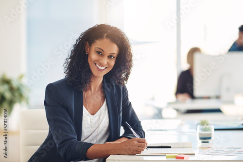 Fototapeta Confident and smiling portrait of a businesswoman, marketing executive or corporate worker working, writing and planning schedule in notebook at an office