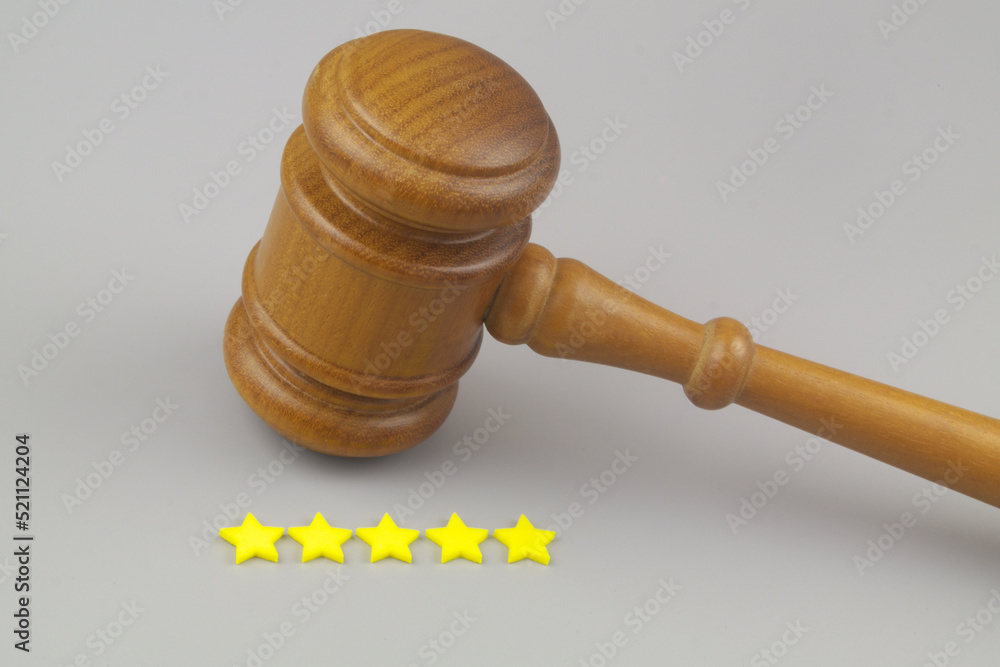Attorney rating concept. Judge gavel with five stars on gray background. Copy space for text. Attorney rating concept. Judge gavel with five stars on gray background. Copy space for text.