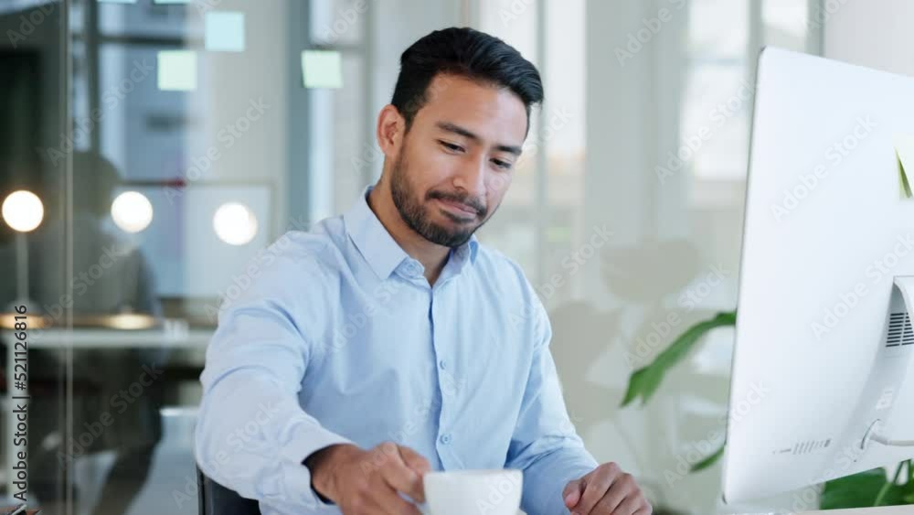 Relaxed and happy business man drinking coffee and reading email on computer in modern office. Professional excited about good news or feedback. Cheerful guy feeling positive about an idea Relaxed and happy business man drinking coffee and reading email on computer in modern office. Professional excited about good news or feedback. Cheerful guy feeling positive about an idea
