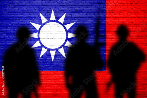 Taiwan  flag painted on brick wall with soldiers shadows. Taiwan island defence photo