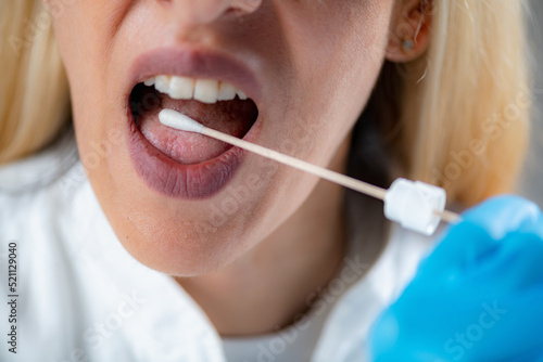 Inserting a swab into the mouth, collecting a saliva sample for DNA analysis