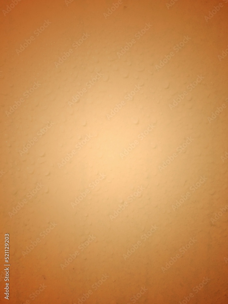 Abstract background with tan color with white yellow light in the middle.